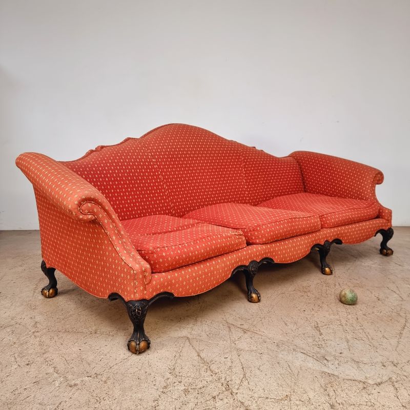 Huge curved sofa decorated with claw feet