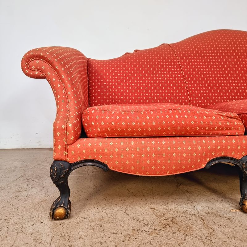 Huge curved sofa decorated with claw feet. Alternate view