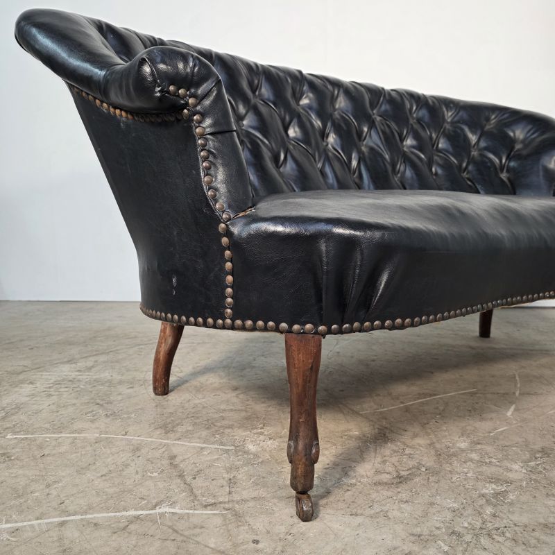 Curved Napoleon III black moleskin sofa. Alternate view